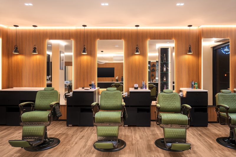 The row of olive barber chairs and mirrors inside On the Mark Barber Shop in Williamsburg, Brooklyn